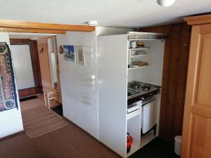 a kitchen with a white refrigerator and a stove at Ferienwohnung Heustüble in Hinterzarten