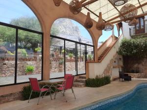 a house with a swimming pool and a table and chairs at Centenario Los Arroyitos in Bernal