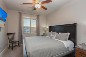 a bedroom with a bed and a ceiling fan at 96 PV Luxury Getaway with Private Hot Tub, Ping Pong, Community Pool, Water Park and Lazy River in Santa Clara +128 photos