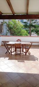 a wooden table and two chairs on a patio at Casa Cecilia in Favignana