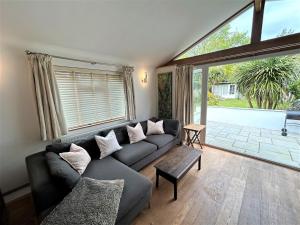 a living room with a couch and a large window at Spacious home near the Marinas with ample parking in Lymington