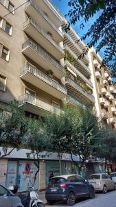 a large building with cars parked in front of it at La Casa dell'Architetto in Bari