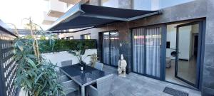 a balcony with a black table and some plants at LOFT Deluxe Cumbre del Mar in El Campello
