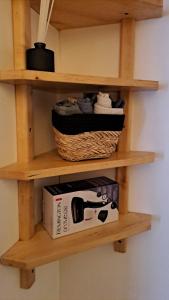 a shelf with a basket and a box on it at George&K Apartament in Larvik