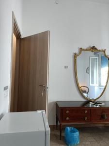 a bedroom with a bed and a mirror and a dresser at B&B Mavipagi in Verona