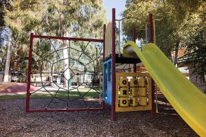a playground with a slide in a park at Crystal Brook Tourist Park in Doncaster East