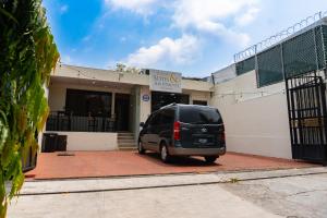 a van parked in front of a building at Hotel La Capilla - Suites & Apartments San Benito in San Salvador
