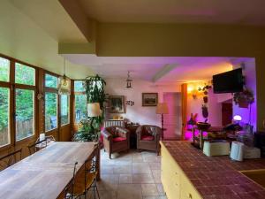 a living room with a living room with purple lighting at Refuge Raffiné - 2 Salons, Double Jacuzzi, Jardin in Chatou