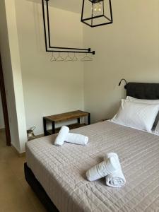 a bedroom with a bed with two towels on it at Atalaya Villa in Stalís
