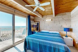 a bedroom with a bed and a large window at Caravelle 1 in Ocean City