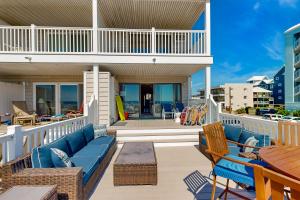 a balcony with a blue couch and chairs at Caravelle 1 in Ocean City