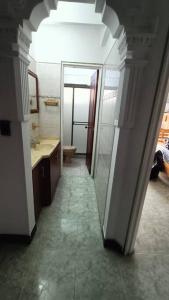 a hallway to a bathroom with a sink and a mirror at apartment in neiva goliat 102 in Neiva