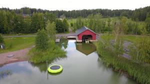 an aerial view of a house and a boat in the water at 4 hengen luhtimökki in Naantali