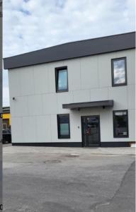 a white building with a black roof at Betooni Stay in Tartu