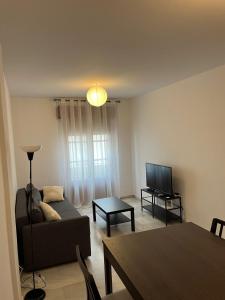 a living room with a couch and a table at La Casa del Tambor in Córdoba