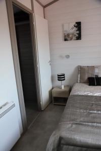 a bedroom with a bed and a sliding glass door at Chalet in Hudimesnil