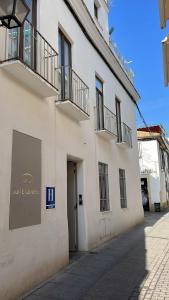 a white building with a sign on the side of it at La Casa del Tambor in Córdoba