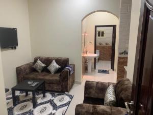a living room with a couch and a chair at شقق ضيافه خاصه 5391 in Yanbu