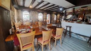 a dining room with a large wooden table and chairs at Hôtel La Fontaine in Saint-Imier +20 photos