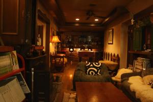 a living room with a couch and a table at Grandpapa in Kutchan