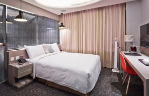 Postel nebo postele na pokoji v ubytování V-one Hotel - Ningxia No. 2 Inn