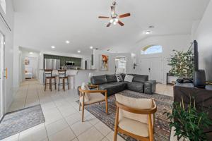 a living room with a couch and a table at Stunning 4-bedroom Villa w/ Pool - Close to Disney Parks and Gulf Courses! in Davenport