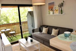 a living room with a couch and a table at Le Petit Moulin in Gradignan