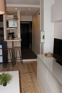 a kitchen with a table and a counter top at Le Petit Moulin in Gradignan