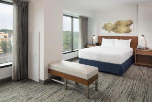 a hotel room with a bed and a window at Hilton Fairfax, Va in Fairfax