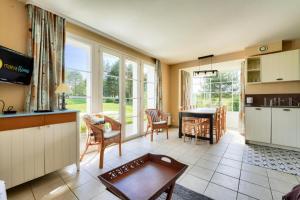 eine Küche und ein Wohnzimmer mit Tisch und Stühlen in der Unterkunft Les Maisons de Belle Dune - maeva Home - Maison 4 Pièces 8 Personnes - Prestige MAE-7746 in Fort-Mahon-Plage