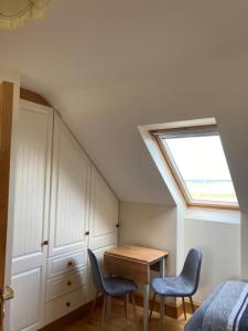 a room with a bed and a table and two chairs at Killard House in Caherlean