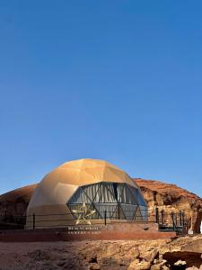 a domed building in the middle of a desert at RUM SUNRlSE LUXURY CAMP in Wadi Rum