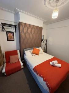 a bedroom with a bed and a chair in it at Rooms Anfield- 5 mins from LFC in Liverpool