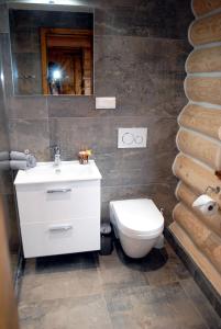 a bathroom with a white sink and a toilet at Chaty NOVA pri Pieninách in Spišská Stará Ves +35 photos