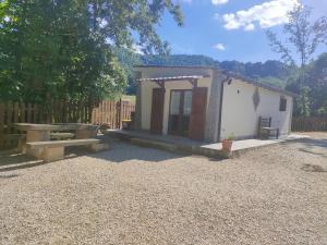 a small shed with a picnic table and a bench at La Casetta della valle di Civita in Bagnoregio