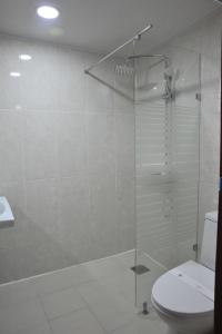 a bathroom with a glass shower with a toilet at Palace Hotel Gwangju in Gwangju