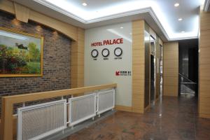 a hallway with clocks on a wall in a building at Palace Hotel Gwangju in Gwangju