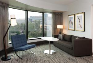 a living room with a couch and a chair at Hilton Fairfax, Va in Fairfax