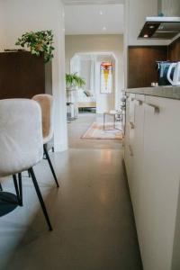 a kitchen with a counter and a table and chairs at Boutique 2br Apt With Garden At Fontys in Tilburg