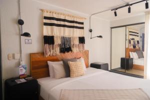 a bedroom with a large white bed with a mirror at Miraflores Apartments in Lima