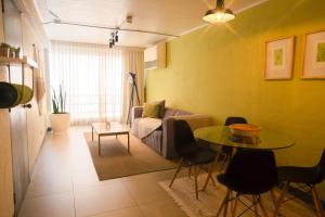 a living room with a couch and a table at Miraflores Apartments in Lima +21 photos