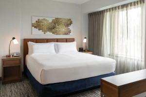 a bedroom with a large white bed and a window at Hilton Fairfax, Va in Fairfax