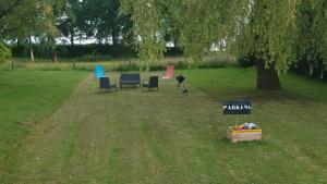 a group of chairs and a sign in a park at le marly's in Wasigny