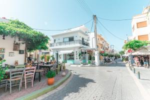 a street in a town with tables and chairs at Granny's House in Kos Town