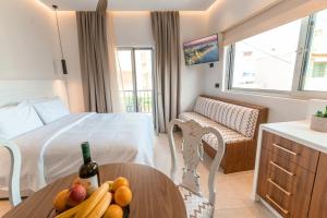 a room with a bed and a table with fruit on it at Granny's House in Kos Town