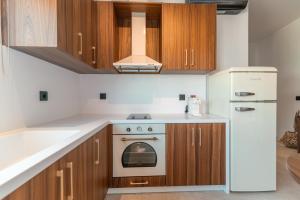 a kitchen with a stove and a refrigerator at Granny's House in Kos Town +35 photos