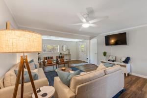 a living room with a couch and a ceiling fan at The Hickory House with Firepit- Boat Ramp Access to Cedar Creek Lake in Tool