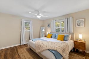 a bedroom with a bed with blue and yellow pillows at The Hickory House with Firepit- Boat Ramp Access to Cedar Creek Lake in Tool