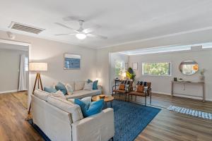 a living room with two couches and a ceiling fan at The Hickory House with Firepit- Boat Ramp Access to Cedar Creek Lake in Tool