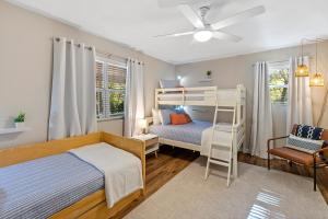 a bedroom with two bunk beds and a chair at The Hickory House with Firepit- Boat Ramp Access to Cedar Creek Lake in Tool